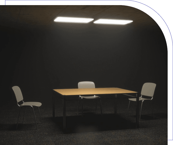 A table and two chairs in the dark.